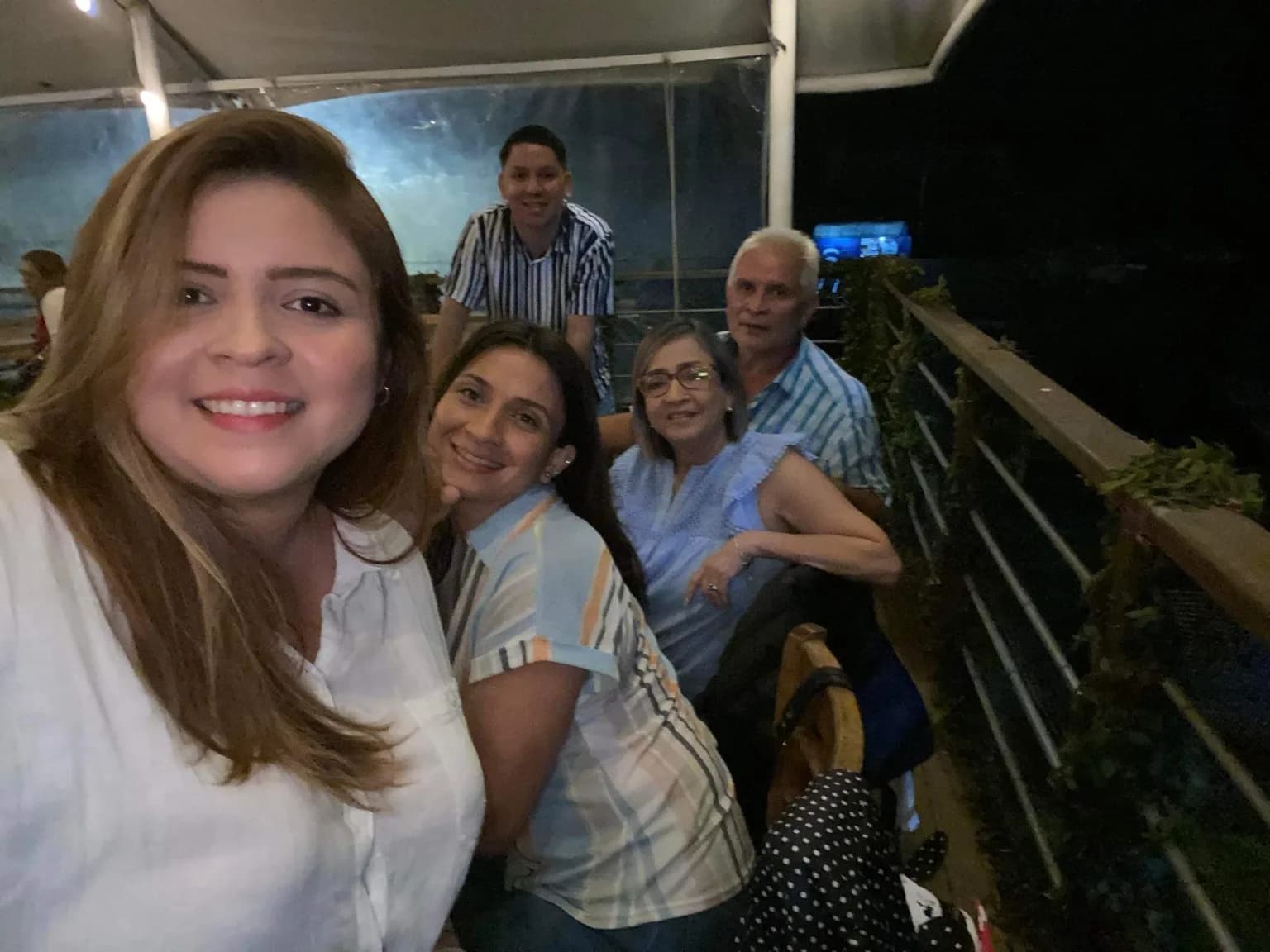 The family crowded into one photograph at dinner in El Salvador, grandparents at the back of the frame