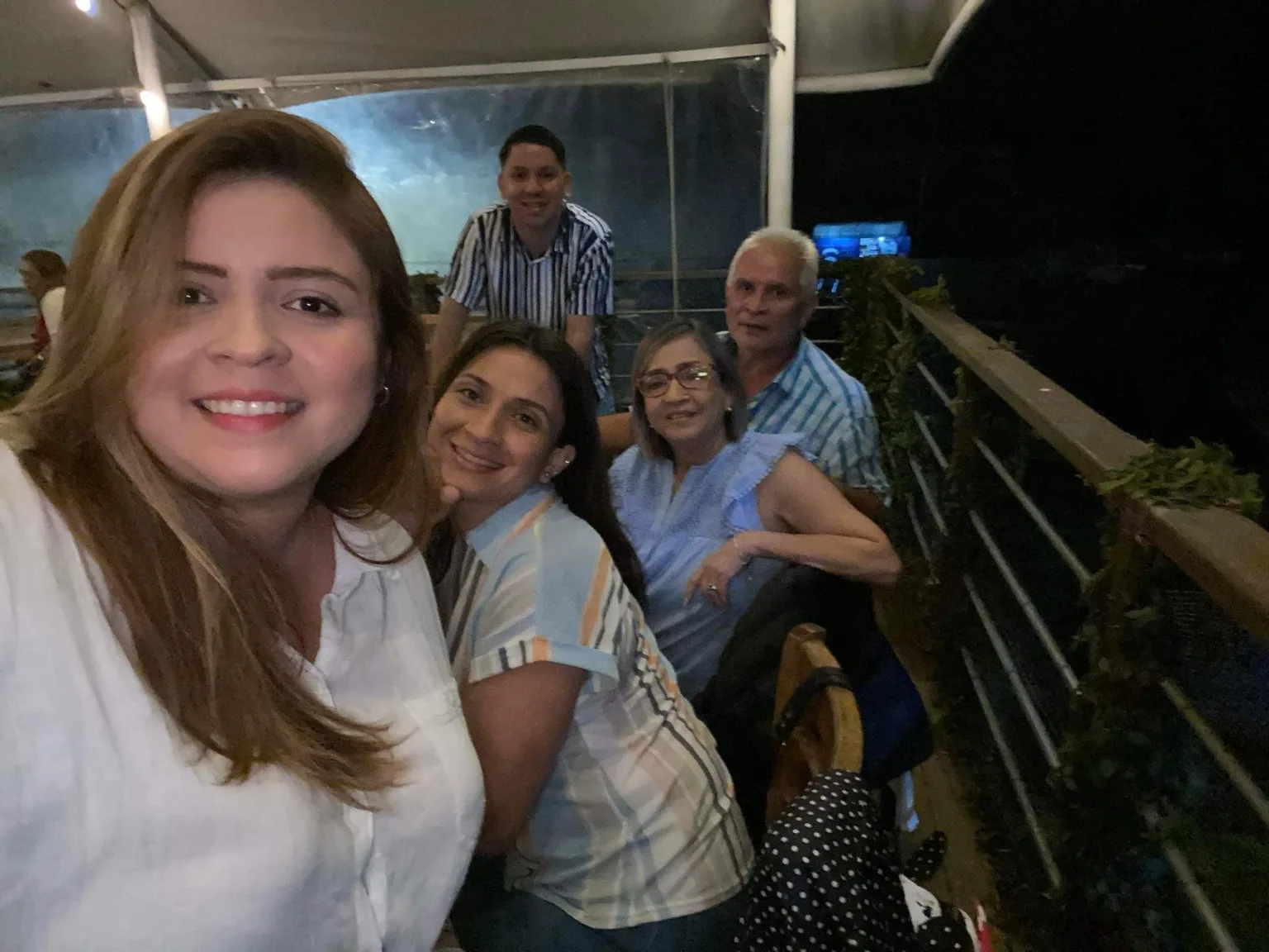 The family crowded into one photograph at dinner in El Salvador, grandparents at the back of the frame